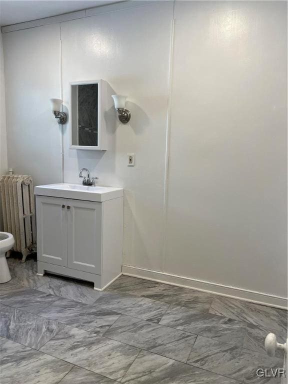 bathroom featuring radiator heating unit and vanity