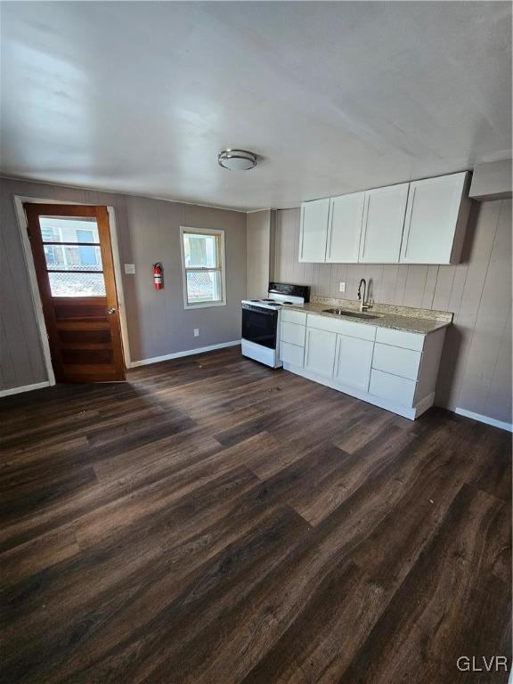 kitchen featuring white electric range, dark hardwood / wood-style floors, white cabinetry, and sink