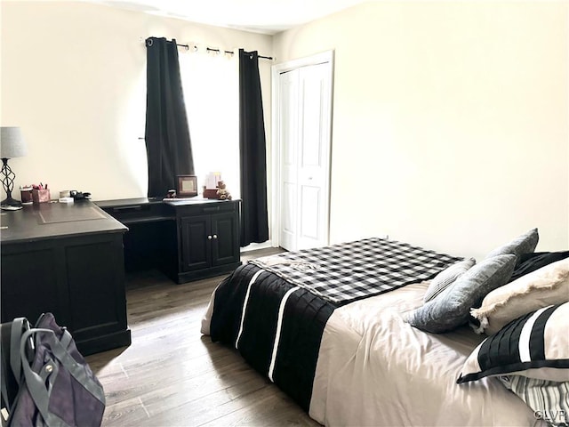 bedroom with light wood-type flooring and a closet