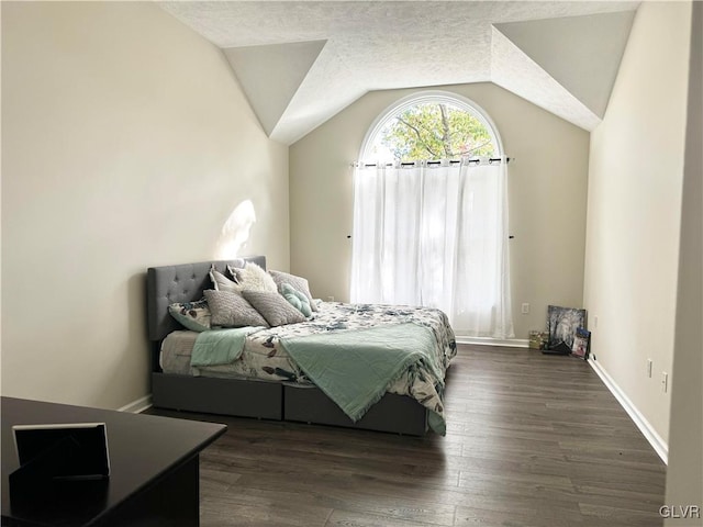 bedroom with dark wood-type flooring and vaulted ceiling