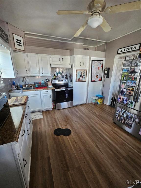 kitchen featuring electric range, sink, white cabinetry, and backsplash