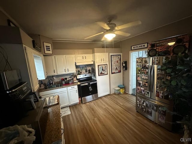 kitchen with light hardwood / wood-style flooring, white cabinetry, stainless steel range with electric stovetop, and ceiling fan