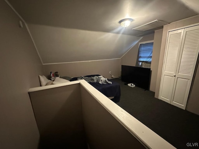 bedroom with a closet and lofted ceiling