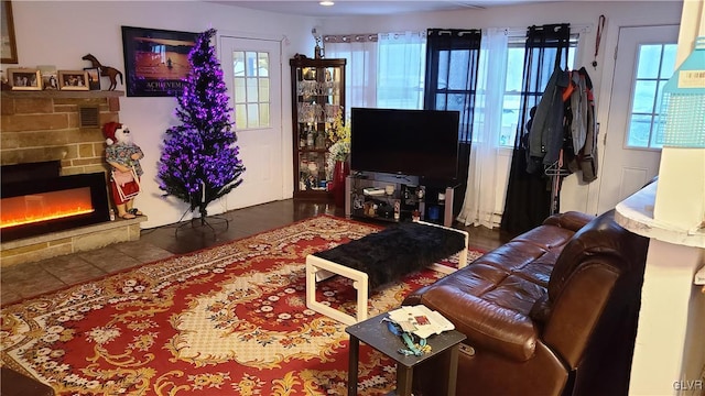 living room featuring a fireplace and a wealth of natural light