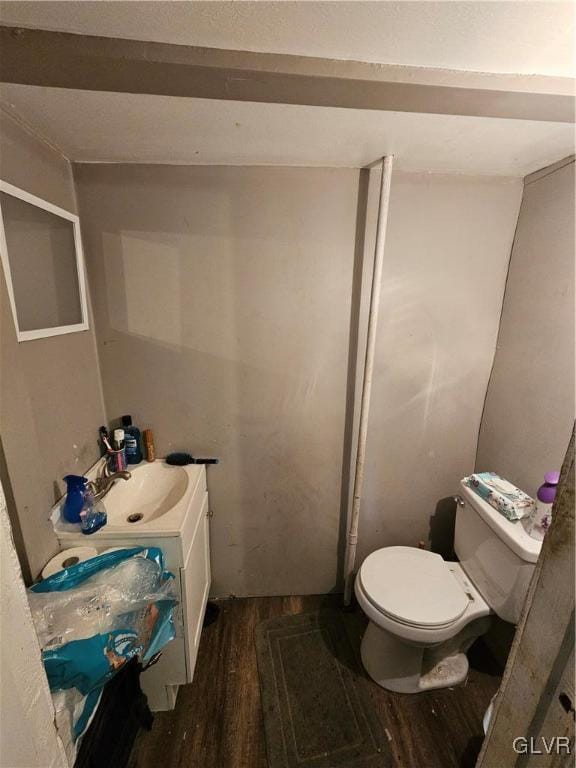 bathroom with hardwood / wood-style floors, vanity, and toilet