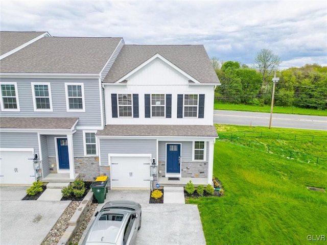 view of front of home with a front yard and a garage