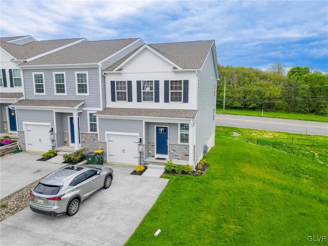 view of front of property featuring a garage and a front yard