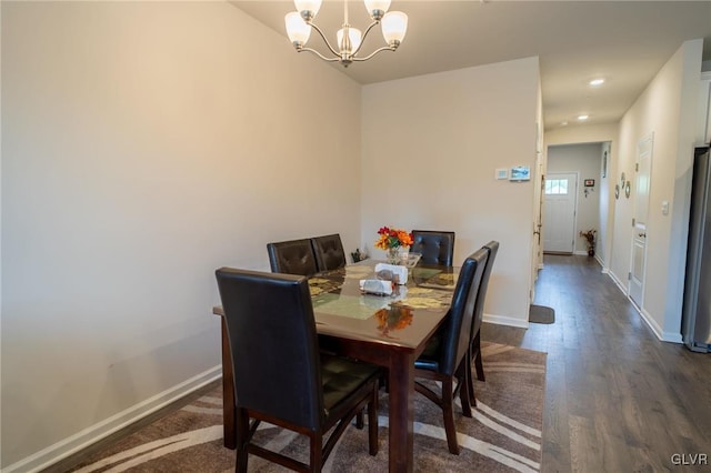 dining room with a chandelier and dark hardwood / wood-style floors