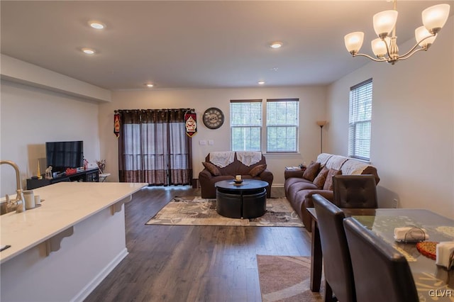 living room featuring dark hardwood / wood-style flooring and a notable chandelier