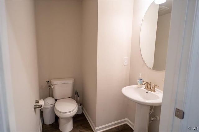 bathroom featuring hardwood / wood-style flooring, toilet, and sink