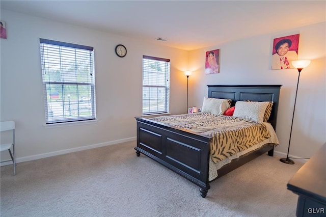 bedroom featuring light carpet