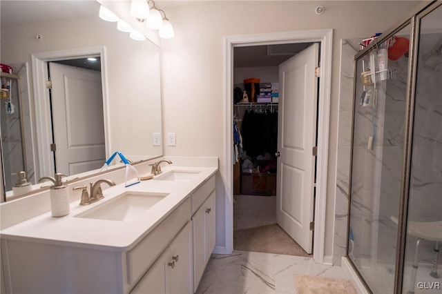 bathroom with vanity and a shower with shower door