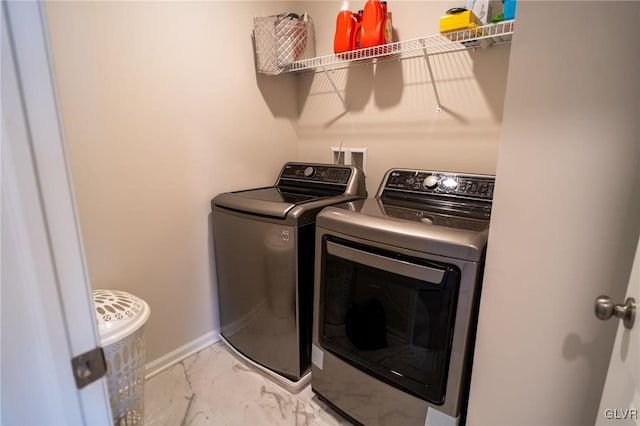 clothes washing area with washing machine and dryer