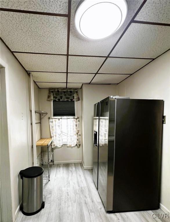 corridor featuring a paneled ceiling and wood-type flooring