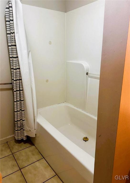 bathroom with tile patterned flooring and shower / tub combo