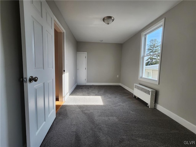 unfurnished bedroom with carpet and radiator heating unit