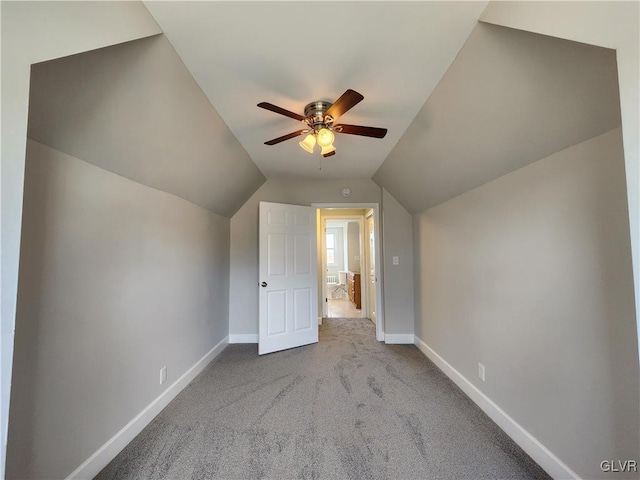 additional living space with light carpet, ceiling fan, and vaulted ceiling