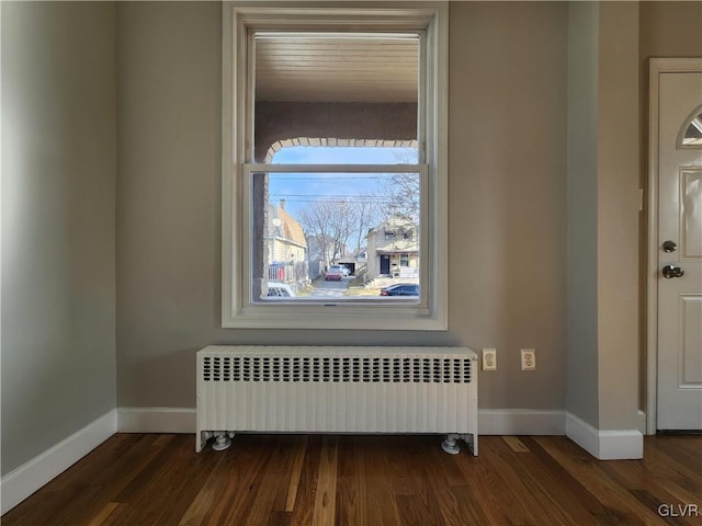 interior space with radiator heating unit and hardwood / wood-style flooring