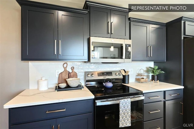 kitchen with appliances with stainless steel finishes and backsplash