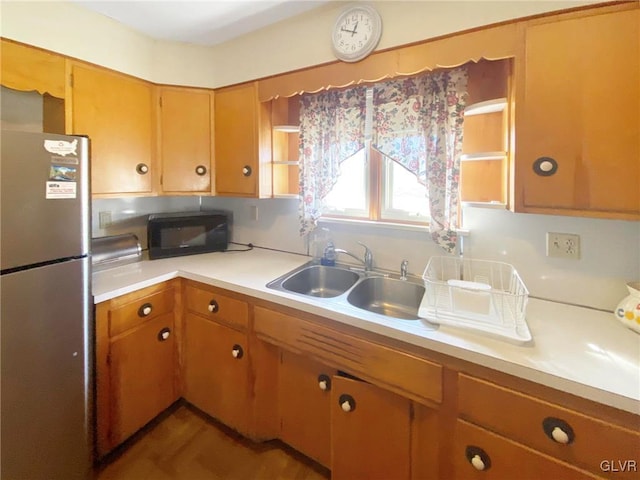 kitchen featuring stainless steel fridge and sink