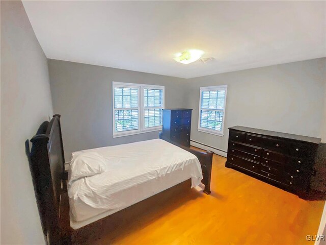 bedroom featuring carpet flooring and a baseboard radiator