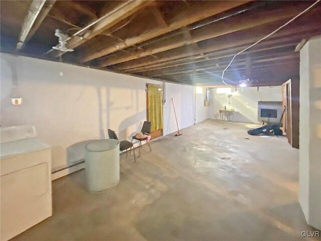 basement featuring washer and dryer and a baseboard radiator