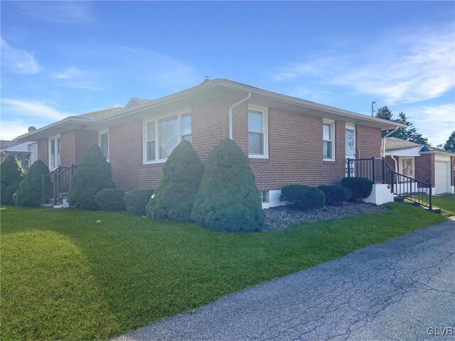 view of side of property featuring a yard