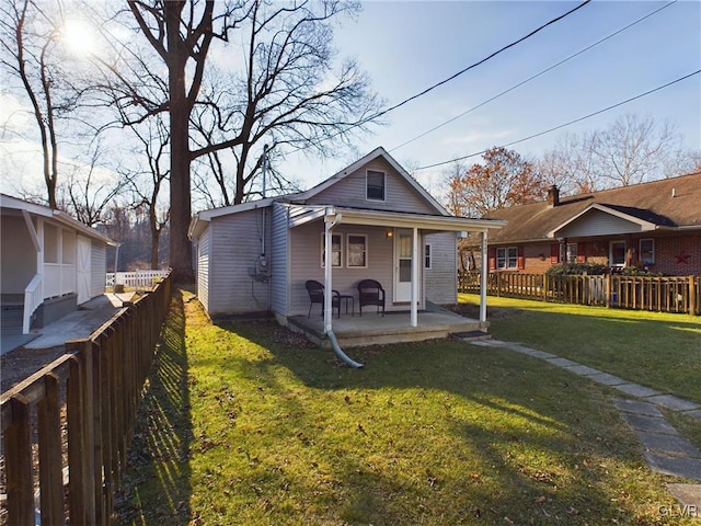 bungalow-style house with covered porch and a front yard