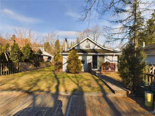 view of front facade featuring a front yard and a deck