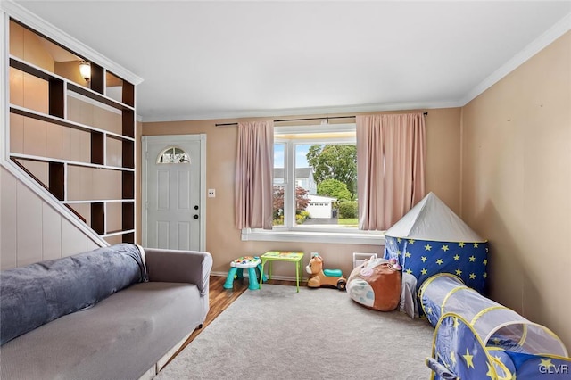 recreation room featuring hardwood / wood-style flooring and crown molding