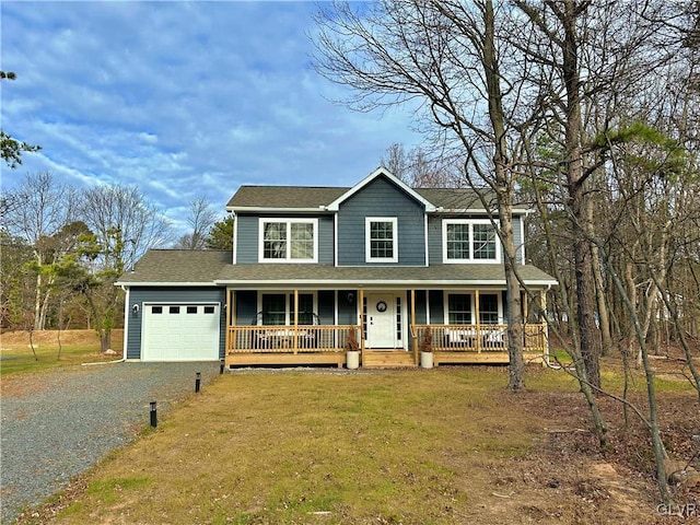 view of front of home featuring a front yard, a porch, and a garage