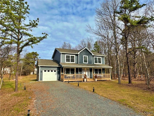 country-style home featuring a front yard, a porch, and a garage