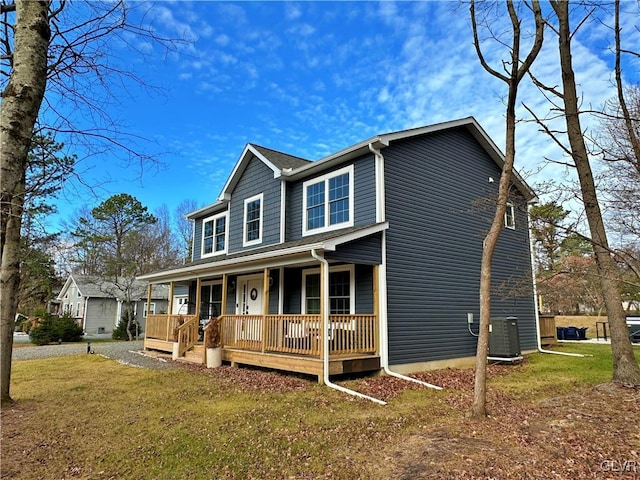 view of front of home featuring central air condition unit, a porch, and a front yard