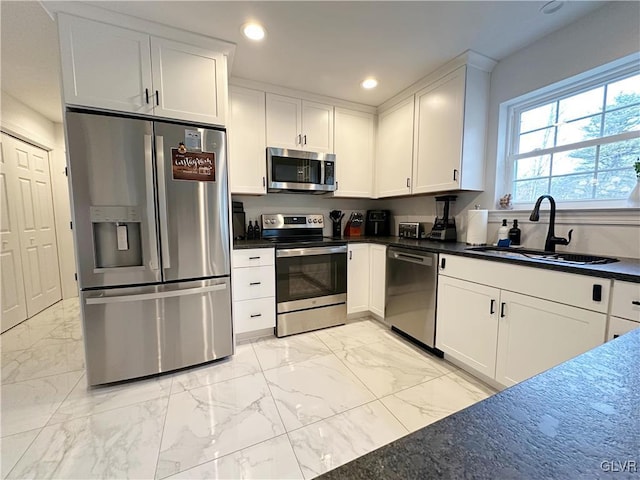 kitchen featuring sink, white cabinetry, and stainless steel appliances