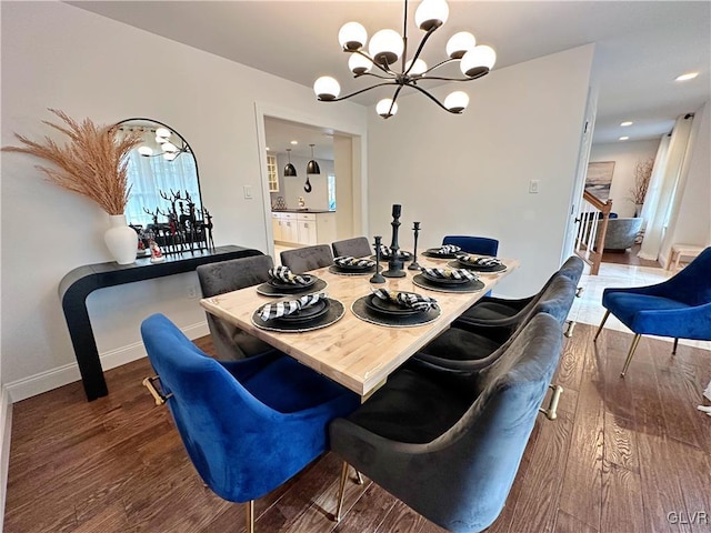 dining area with hardwood / wood-style flooring and a notable chandelier