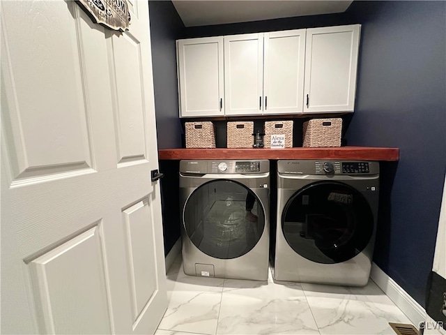 laundry room featuring cabinets and washing machine and clothes dryer