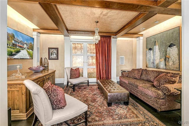 living room featuring beam ceiling, decorative columns, and coffered ceiling