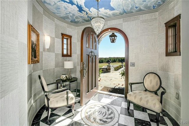 interior space with a wealth of natural light, crown molding, a chandelier, and tile walls