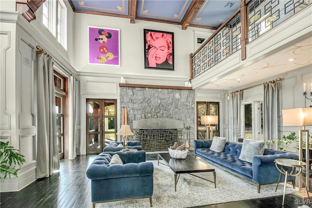 living room featuring plenty of natural light, dark hardwood / wood-style flooring, crown molding, and a high ceiling