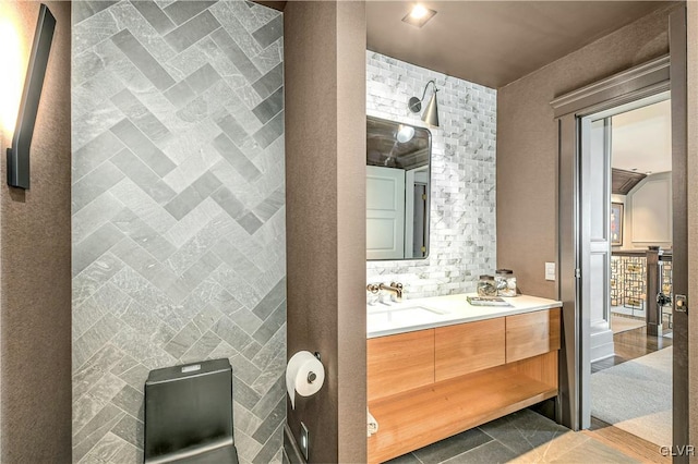 bathroom featuring tile patterned floors, vanity, and tile walls