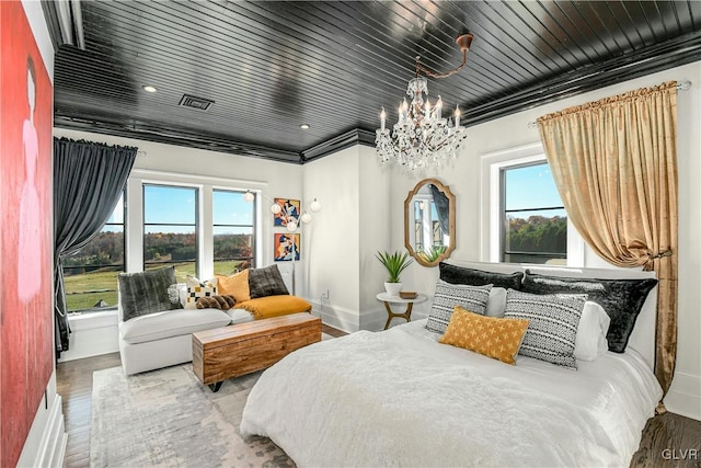 bedroom with hardwood / wood-style flooring, a notable chandelier, wooden ceiling, and multiple windows