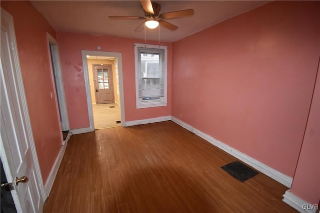 empty room with ceiling fan and wood-type flooring