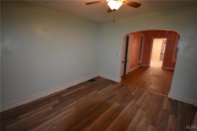 unfurnished room featuring ceiling fan and dark wood-type flooring