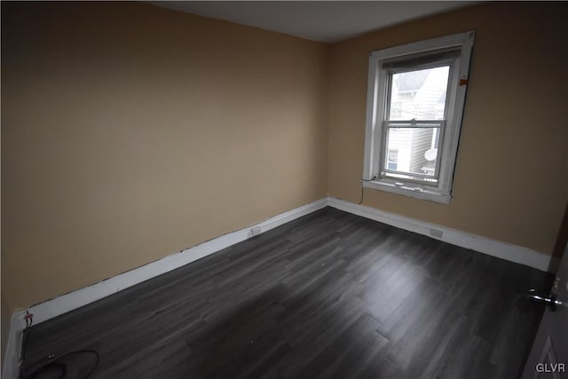 spare room featuring dark hardwood / wood-style flooring