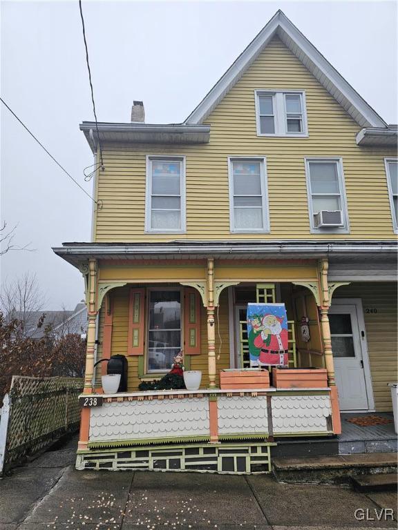 view of front of house with cooling unit and covered porch