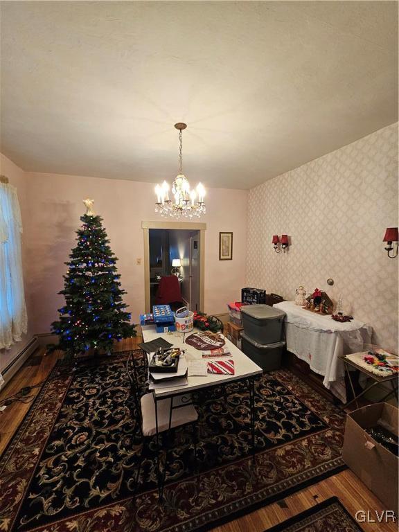 dining area featuring an inviting chandelier and hardwood / wood-style flooring