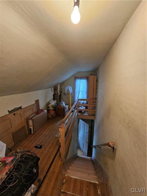 interior space with hardwood / wood-style flooring and vaulted ceiling