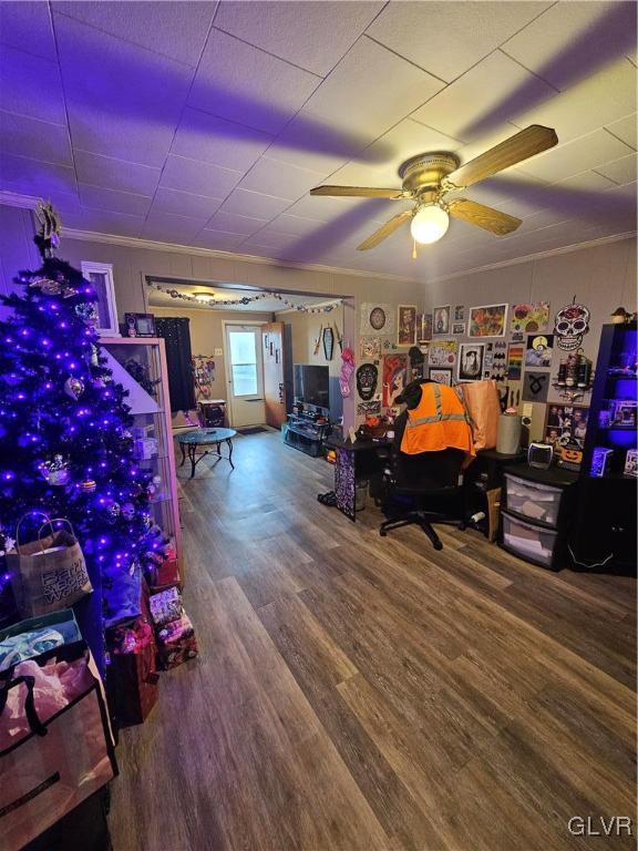 recreation room featuring wood-type flooring, ceiling fan, and crown molding