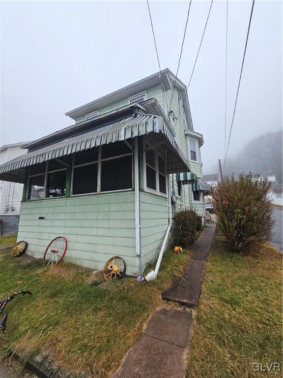 view of side of home featuring a yard