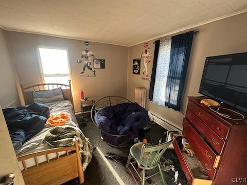 bedroom with radiator heating unit, carpet floors, a baseboard radiator, and crown molding